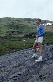Shane Powell stops for a photo shoot on a large slab of rock by the roadside as we continue the final part of the climb to the top [Remastered scan, 25/9/2019]