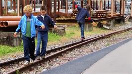 Tao catches one of the rail-walkers falling off the rail