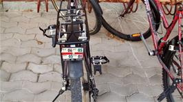 Licence plates still remain on some of the old bikes outside the Volg supermarket, Zillis, even though they were no longer needed after 1988