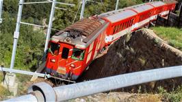 A train emerges from a circular tunnel climb at Deisch, 2.7 miles into the ride