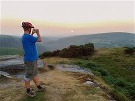 Gavin on Bench Tor as the sun sets in the west beyond Two Bridges