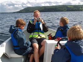 Olly in control of our motor boat on Lake Windermere