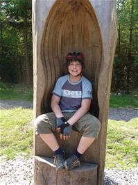 Zac explores the carved chair on the Play Trail