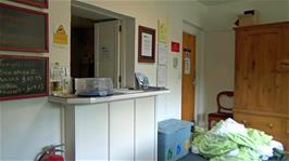 The reception desk at Thorney How Independent Hostel, with more delicious home-made chocolate brownies for sale at a bargain price