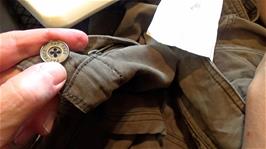 Lawrence has finished sewing the button onto his cycling shorts